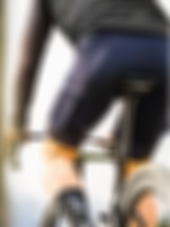 Rear view of a cyclist riding outdoors wearing SQlab ONE14 cycling shorts.