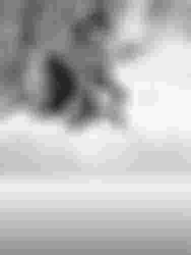 Cyclist riding through a snowy forest trail, wearing winter gear and a helmet, with snow covering the ground and trees.