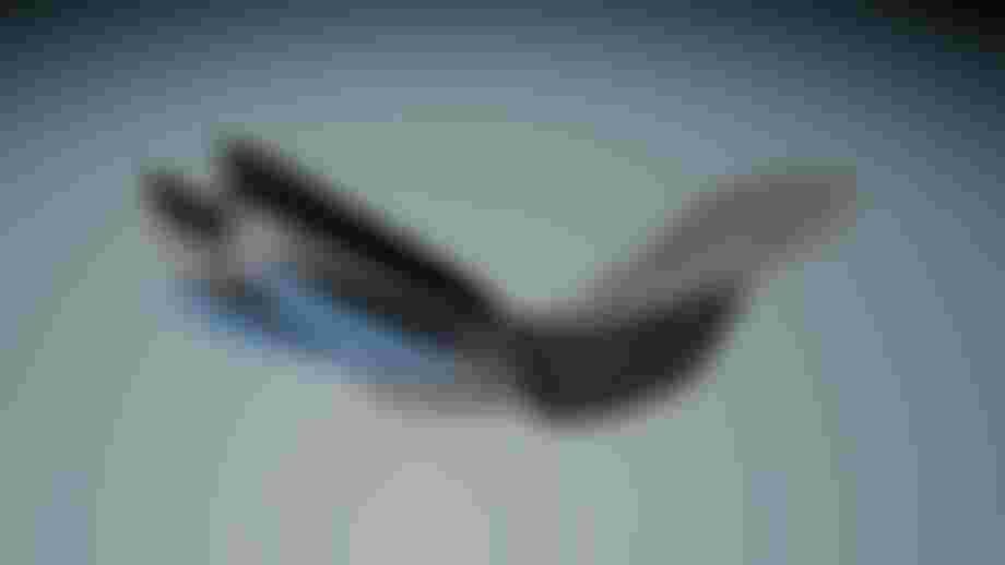 Multilayered shoe insole with varying textures and colors, including blue and grey, displayed in a dynamic, fanned-out position.