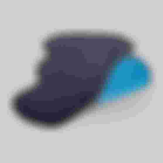 Close-up of the SQ-Pad 12 R showing its ultra-thin, contoured shape and breathable, perforated material with visible blue inner layer.