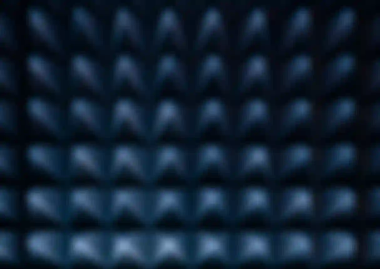 Abstract pattern of illuminated, pyramid-like shapes in a grid, with a blue and dark color palette, creating a textured effect.