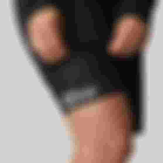 Close-up of the leg cuff on SQlab ONE10 cycling shorts, showing perforated fabric and SQlab logo.