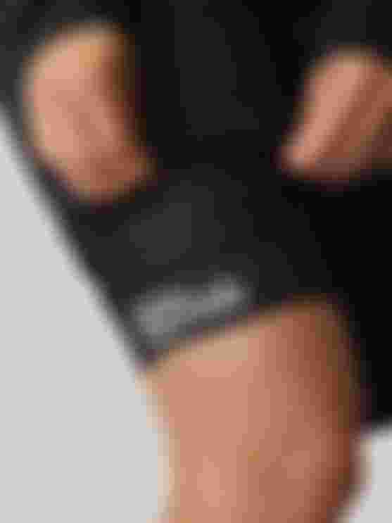 Close-up of the leg cuff on SQlab ONE10 cycling shorts, showing perforated fabric and SQlab logo.