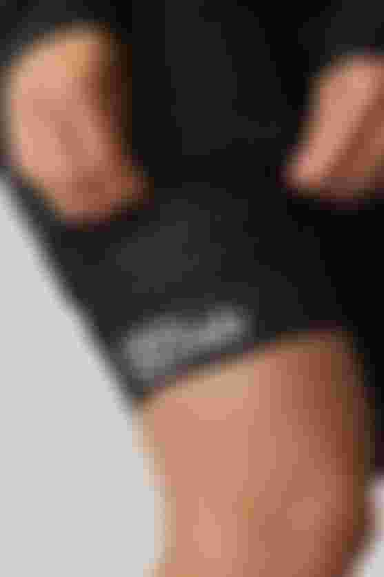 Close-up of the leg cuff on SQlab ONE10 cycling shorts, showing perforated fabric and SQlab logo.