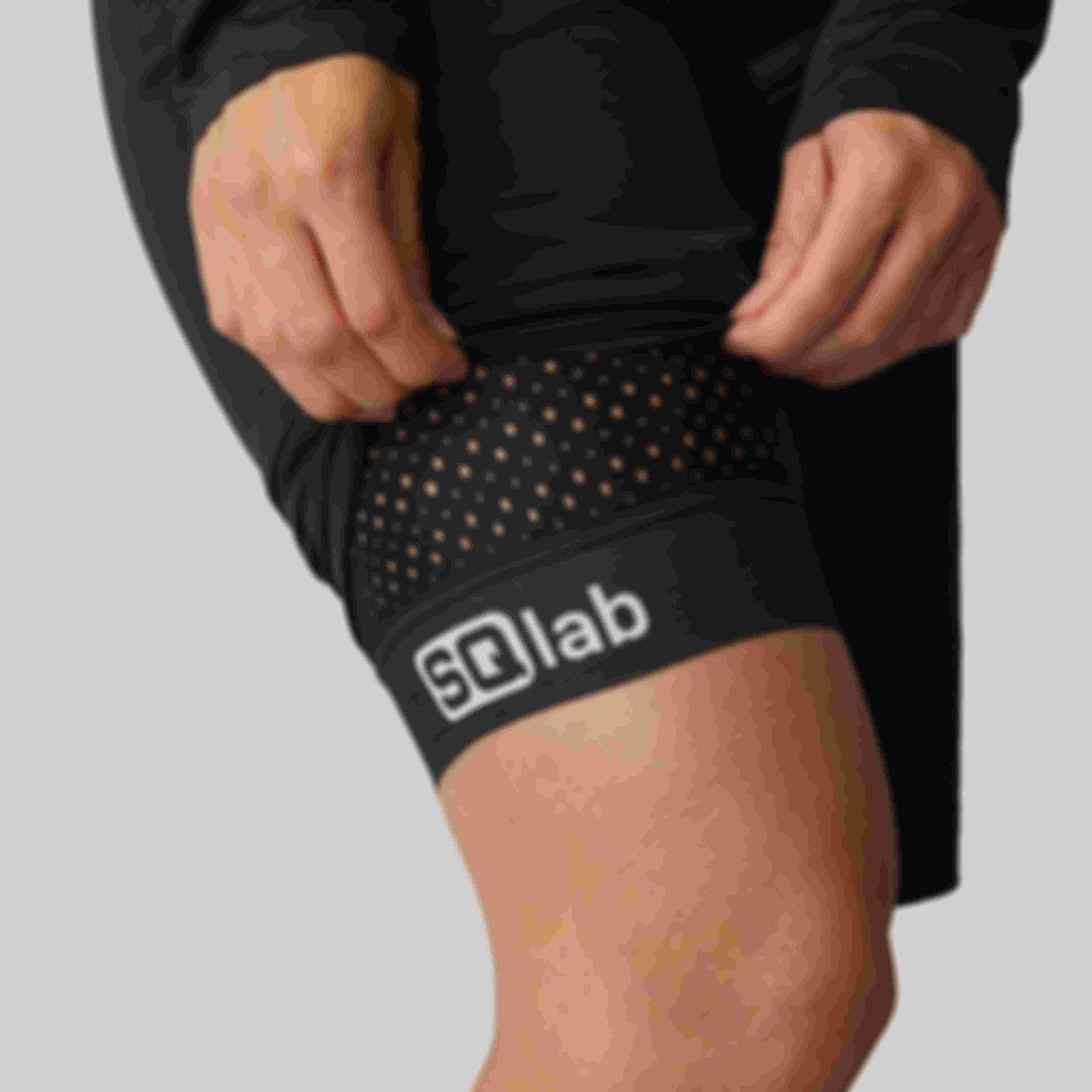 Close-up of the leg cuff on SQlab ONE10 cycling shorts, showing perforated fabric and SQlab logo.