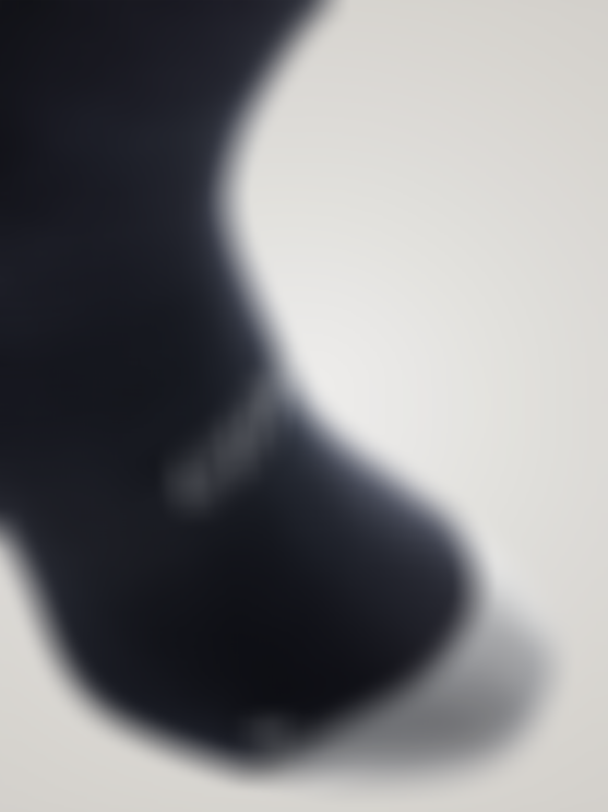 Dark cycling sock with grey toe panel, featuring the SQlab logo and a textured knit around the arch.