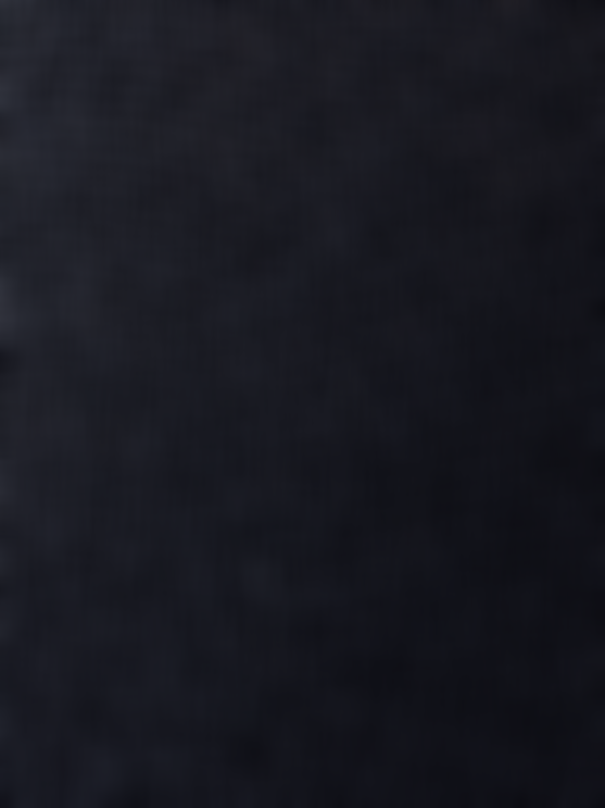 Close-up of a dark sock showing a dense, finely textured knit pattern.