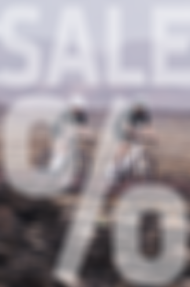 Two cyclists riding on a trail with large "SALE %" text overlaying the image.