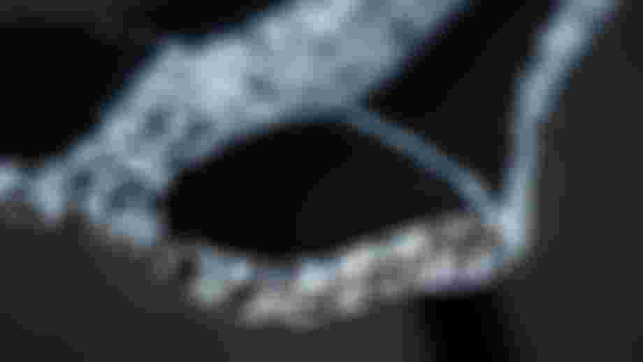 Close-up of the rear section of a black and white speckled SQlab saddle, highlighting the textured Infinergy® padding insert with subtle SQlab logo on the saddle tail.