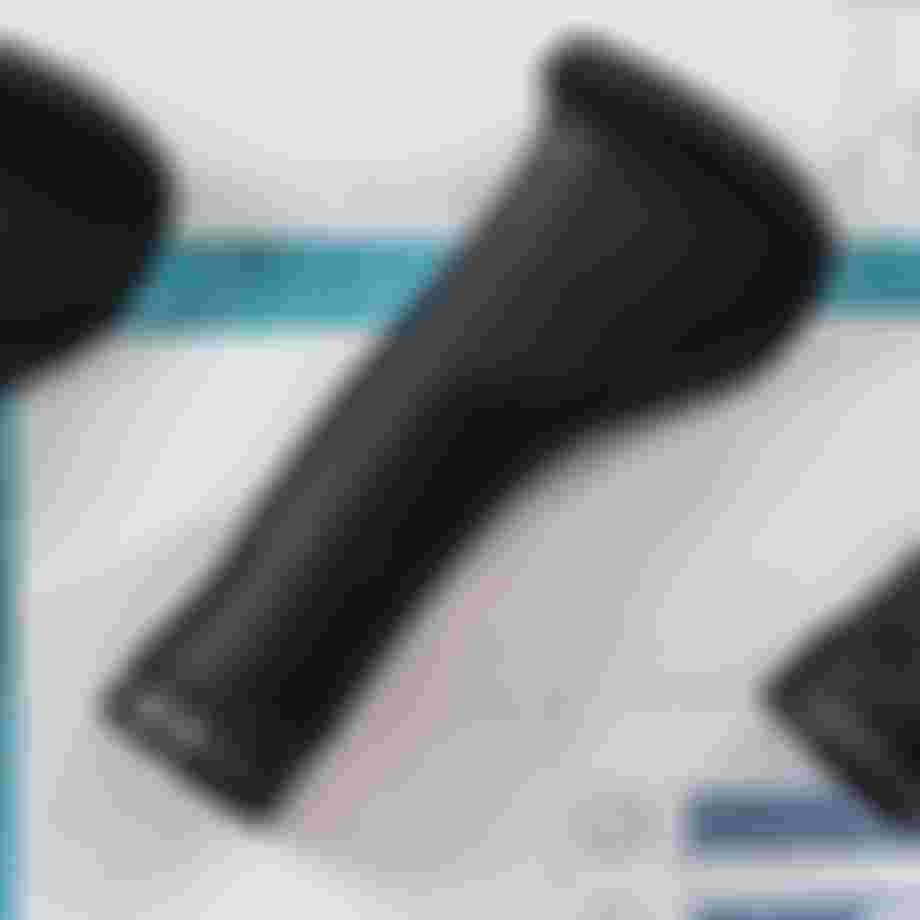 Black ergonomic bike grips on a blueprint background with grid lines and technical drawings.