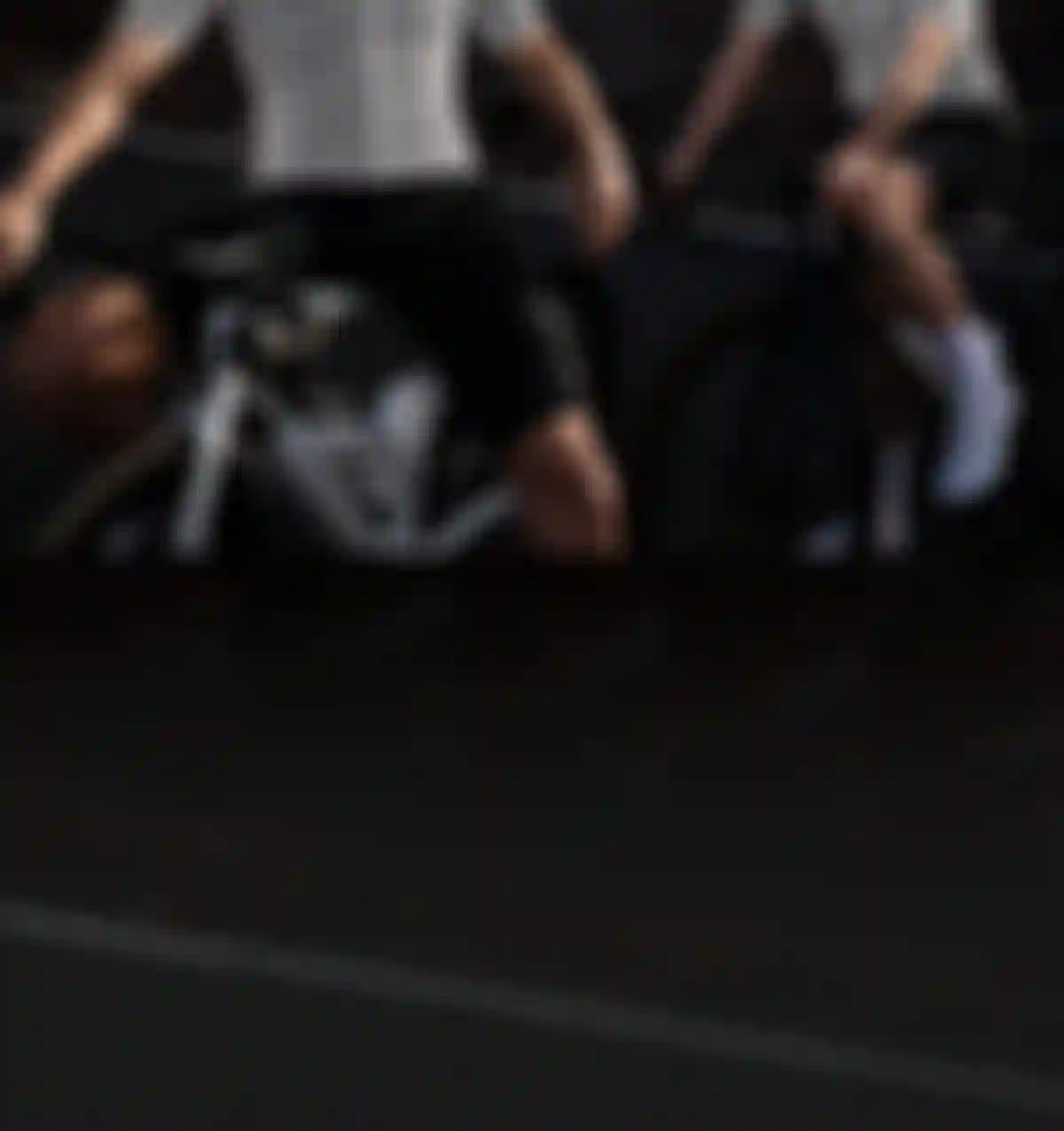 Two road cyclists in white bib shorts and helmets seated on road bikes, with anatomical fit lines overlaid on their jerseys.
