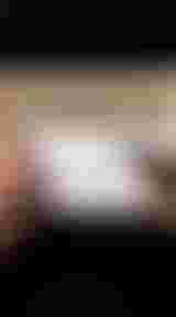 A person measures a cardboard piece with a ruler and marker, displaying bicycle drawings and measurements.