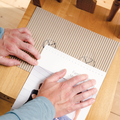 SQlab Measure at Home Set with corrugated measuring board, ruler and instruction booklet on wooden table