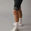 SQlab ONE11 bib shorts in black for mountain biking, detail view of honeycomb gripper cuff with SQlab logo