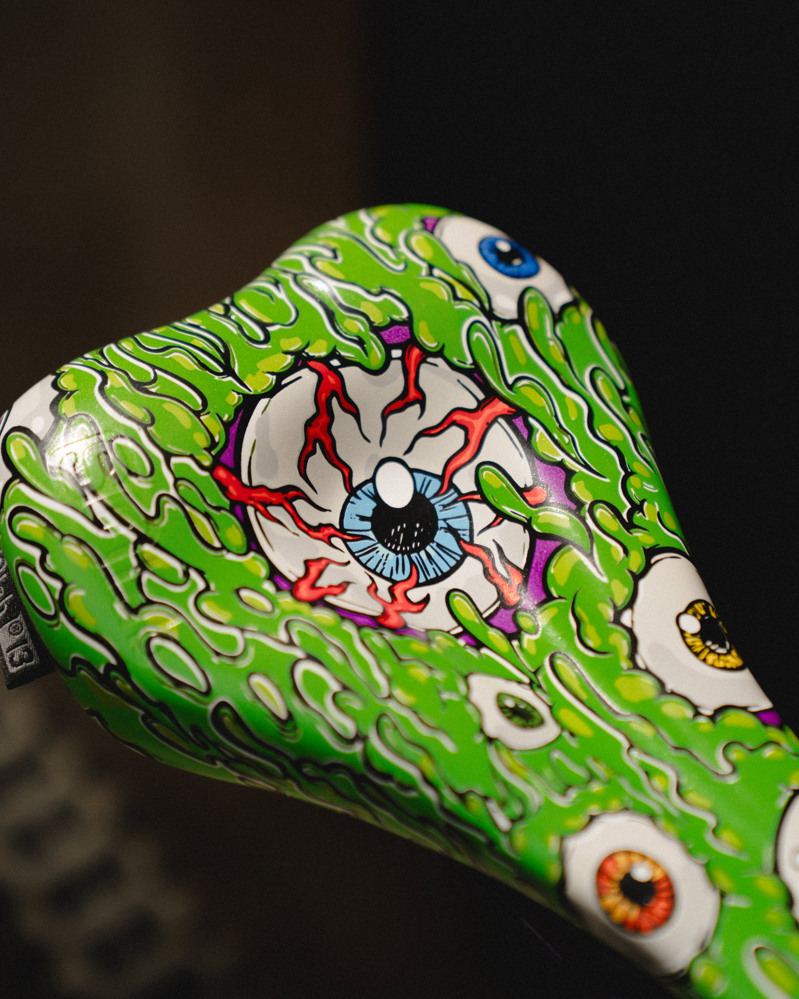 SQlab 6OX ERGOWAVE active 2.2 ltd. Metzger bike saddle in lime green with eyeball graphic print