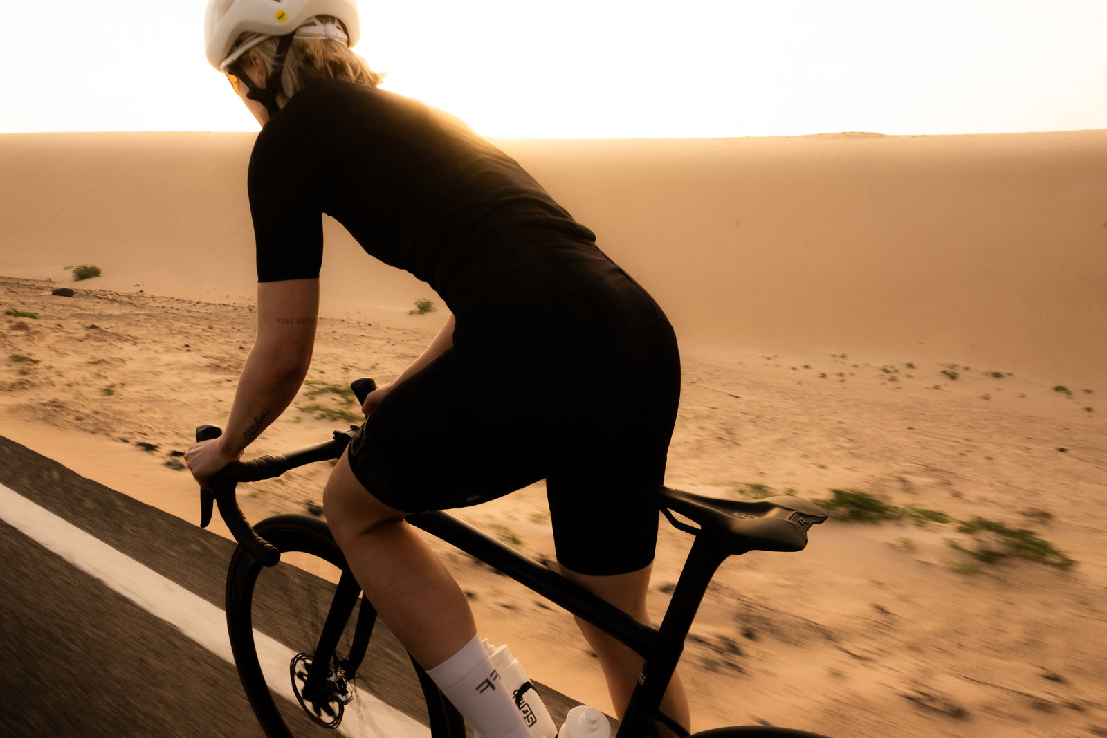 SQlab 612R ErgoWave 2.0 Carbon First Edition saddle during road cycling on a desert road at golden hour