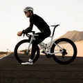 SQlab 612R ERGOWAVE Carbon saddle during road cycling on an open road in an arid landscape